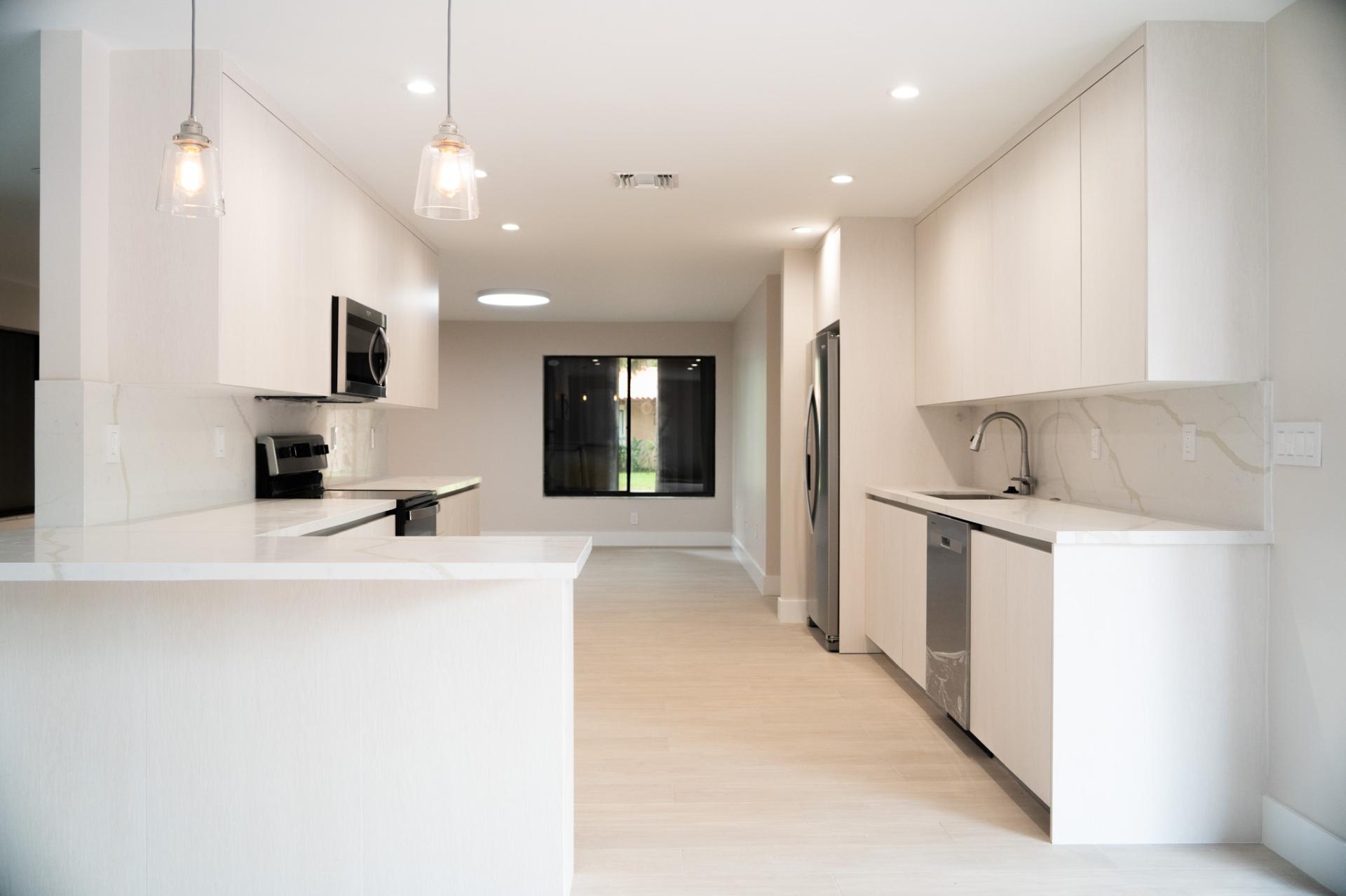 Bright white custom kitchen cabinetry in Miami Lakes